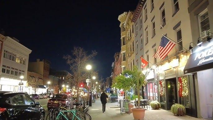Washington Street in Downtown Hoboken at dusk with restaurant lights and pedestrians